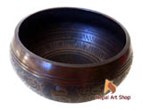 Hand-forged Nepalese singing bowls with intricate patterns, full of history and energy.